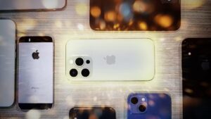 Collection of various iPhone models arranged on a table,