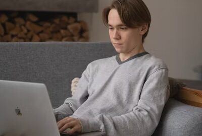 Man using a MacBook on a Couch